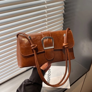 Vintage caramel brown oil-skin baguette bag with bold silver buckle and knotted shoulder strap