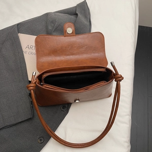 Retro brown faux leather baguette bag showing spacious interior compartments and twin straps