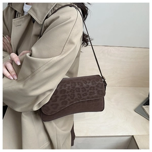 Fashionable dark coffee leopard print shoulder bag worn by model in a trench coat