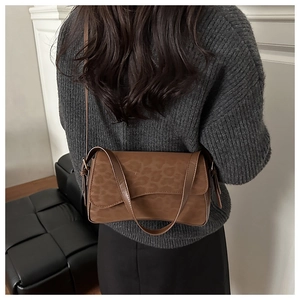 Brown leopard print underarm bag shown on model highlighting vintage shoulder bag style