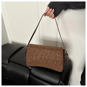 Detail of leopard print flap shoulder bag in brown faux suede with knotted strap detail