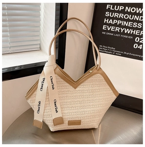 Detail of the woven texture and fashion leather tag on a stylish beige tote bag