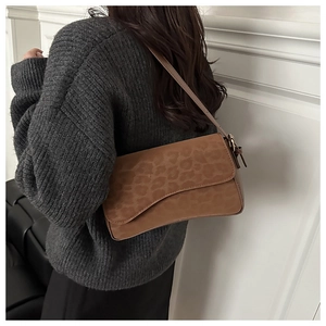 Brown leopard print suede shoulder bag styled with a dark grey knit sweater on model