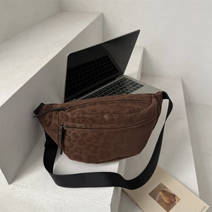 Brown leopard print fanny pack with adjustable strap on a white minimalist display