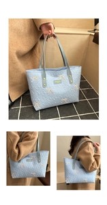 Close-up of quilted tote bag with embroidered bow and embossed logo pattern details
