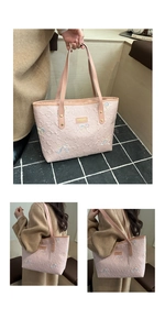 Close-up of pink tote bag with heart quilting and colorful sequined bow detail