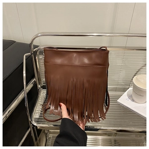Detailed view of brown retro tassel shoulder bag in PU leather with long fringe decor
