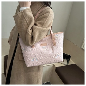 Pink quilted tote bag with letter embossing and rainbow sequin butterfly accents