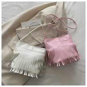 Detail of white and pink minimalist crossbody bags with stylish long fringe tassels