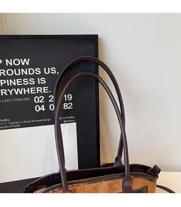 Gros plan des bandoulières en cuir marron avec coutures précises et texture en daim de luxe