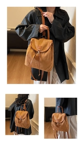 Gros plan d'un sac à dos en daim marron avec cordon de serrage et détails en cuir vintage