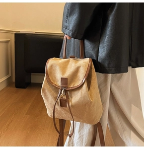 Détail d'un sac à dos en cuir mat kaki avec cordon de serrage et boucle métallique
