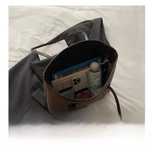 Detail view of large brown leopard tote bag capacity showing tablet and daily essentials