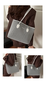 Detail of grey leopard print tote bag with FASHION text and dual shoulder straps
