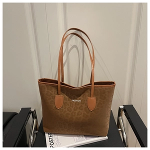Detail van de grote bruine tote bag met luipaardprint, suède textuur en FASHION-logo