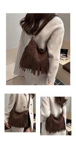 Detail of dark brown leopard print suede hobo bag with long tassels and wide shoulder strap