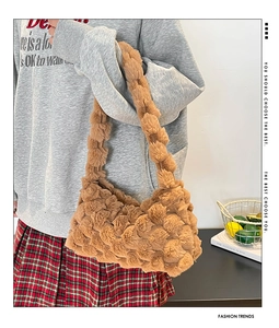 Detailed close-up of brown plush shoulder bag featuring a unique bubble texture design