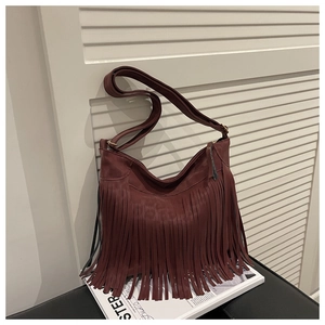 Detail of burgundy fringe crossbody bag in matte faux leather with wide shoulder strap