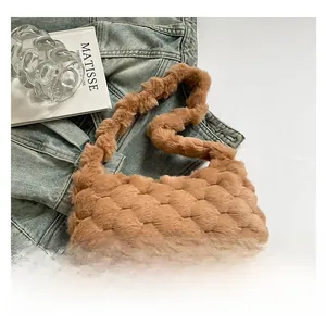 Detail of caramel plush tote bag with bubble texture next to artistic props and denim