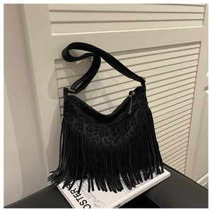 Close-up of black fringe crossbody bag with leopard print details and adjustable strap