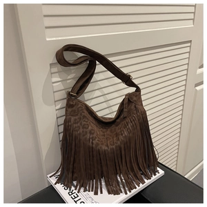 Close-up of brown suede shoulder bag featuring leopard print pattern and long fringes
