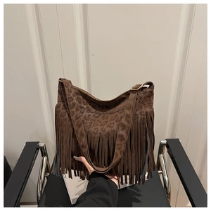 Close-up of brown leopard print tassel shoulder bag in bohemian suede style