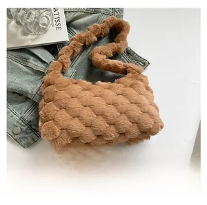 Detail of brown faux fur tote bag showing textured woven pattern and plush material