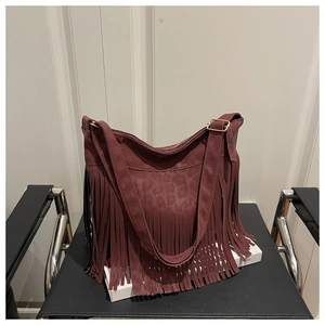 Detail of burgundy tassel shoulder bag with leopard embossed texture and long fringe
