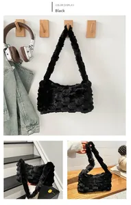 Detail of black plush crossbody bag featuring unique wavy faux fur texture and soft strap