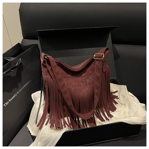 Detail of burgundy fringe shoulder bag with leopard print on velvet-like texture