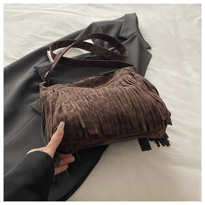 Detailed view of brown leopard print tassel shoulder bag in soft suede material