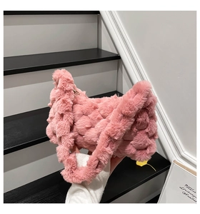 Close-up of pink faux fur woven texture and plush square patterns on the shoulder bag