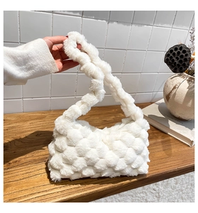 Detail view of the white plush crossbody bag with chunky honeycomb weave texture