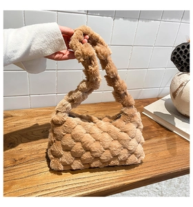 Detailed texture of brown plush handbag with chunky woven faux fur design