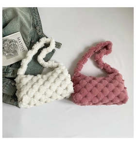 Detail of plush checkerboard shoulder bags in white and rose pink colors