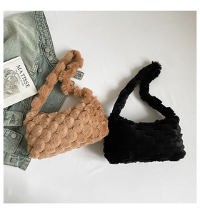 Close-up of plush faux fur tote bags with textured weave pattern in khaki and black colors