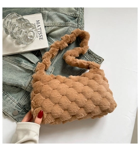 Detail of caramel plush shoulder bag with textured weave and soft faux fur material