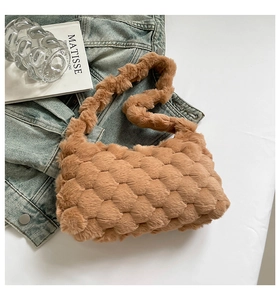 Close-up of brown plush handbag featuring quilted texture on woven faux fur material