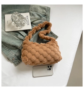 Detail showing the brown plush fuzzy bag with a unique square textured pattern