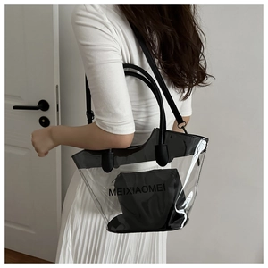 Detail view of a waterproof transparent PVC tote bag with black leather straps and inner pouch