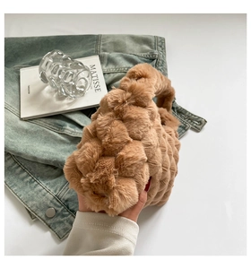 Detailed view of brown plush faux fur handbag with 3D bubble texture and short handle