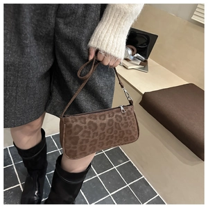 Close-up of leopard print baguette bag with silver zipper and narrow shoulder strap