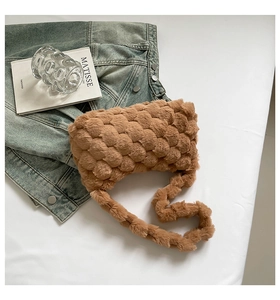 Close-up of khaki plush woven shoulder bag featuring thick grainy knit texture
