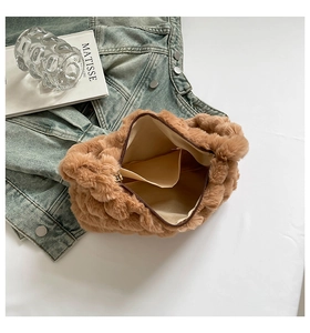 Detailed interior of plush shoulder bag with smooth zipper and beige fabric lining