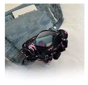 Floral pleated handbag interior showing capacity for phone and cosmetics