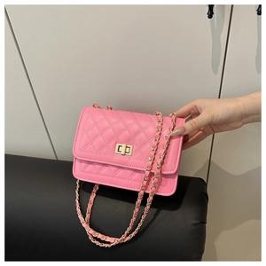 Detailed view of pink quilted PU leather flap bag with gold chain and metal turn-lock