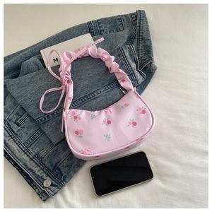Detail of floral hobo bag with pink rose print and stylish ruched handle design