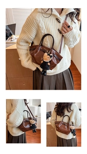 Close-up of brown glossy faux leather handbag with a plush cartoon charm and strap