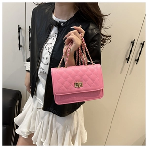 Detailed view of pink quilted leather chain bag featuring a gold-tone twist lock closure