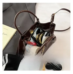Internal view of a brown bucket bag showing large capacity for phone and cosmetics